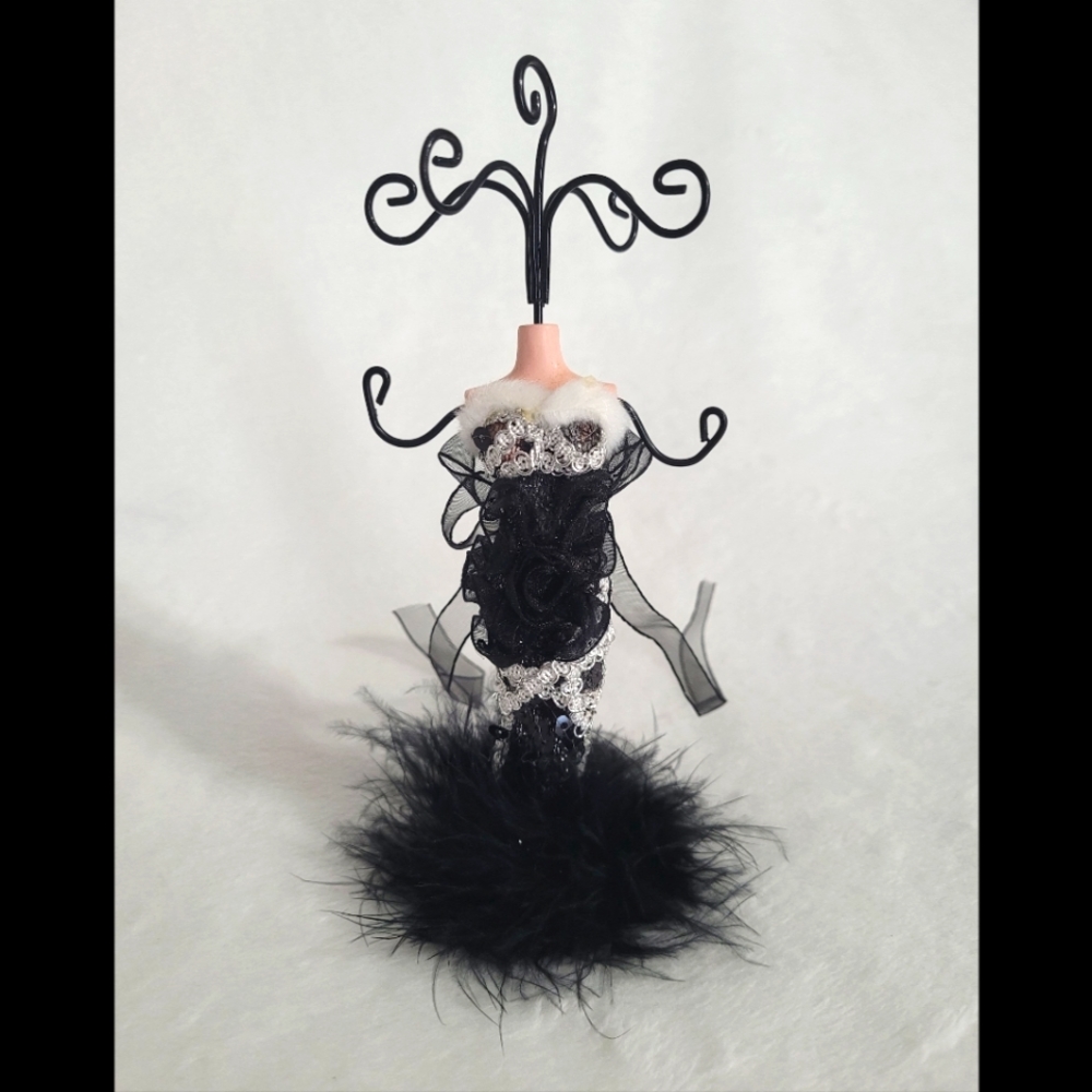 Jewelry stand/holder on porcelain manican with detailed black dress 7 prongs.